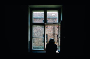 woman looking at the window at a world of change