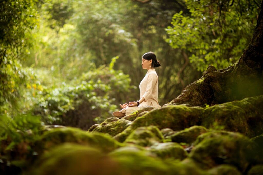 woman practicing yuugen by meditating in nature