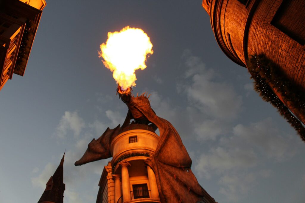 dragon breathing fire atop a building